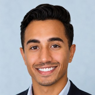 Keith Andrade, smiling, in a navy blazer over a light-blue shirt.